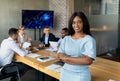Modern Entrepreneur. Black Businesswoman Posing In Conference Room During Meeting With Colleagues Royalty Free Stock Photo