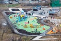 Modern equipped playground for children located between multistory residential buildings