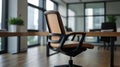 A modern ergonomic office chair with focus on its sleek armrest, clean workspace visible in the background, professional and Royalty Free Stock Photo