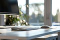 Modern Ergonomic Workspace with Height-Adjustable Desk, Keyboard, and Mouse under Natural Light Royalty Free Stock Photo
