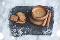 Espresso cup with winter decoration and cookies in snow