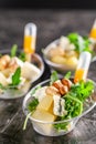 Modern European appetizer. Mini salad with gorgonzola, pear and roasted cashews. Orange dressing in sauceboat, capsule, pipette.