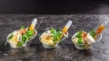 Modern European appetizer. Mini salad with gorgonzola, pear and roasted cashews. Orange dressing in sauceboat, capsule, pipette.