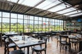 Modern European Restaurant in semi outdoor area with view from the outside and transparent roof Royalty Free Stock Photo