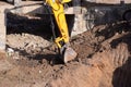 The modern excavator JCB performs excavation work on the construction site Royalty Free Stock Photo