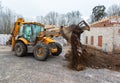 The modern excavator performs excavation work on the construction site. Front view of a digger bucket of digging ground as a part Royalty Free Stock Photo