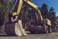 The modern excavator performs excavation work on the construction site Royalty Free Stock Photo