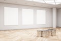 Modern exhibition hall interior with wooden flooring, shiny golden seat and empty mock up frame on concrete wall. Gallery concept Royalty Free Stock Photo
