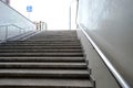 The modern exit from the pedestrian tunnel is empty, up the stairs. Staircase up to the street from the underpass. Stainless steel