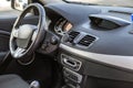 Modern expensive car interior. Dashboard and steering wheel in black color. Transportation, design, modern technology concept