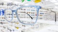 Modern eyeglasses in an optical store with a wide variety of designer frames in the background, representing trends in Royalty Free Stock Photo