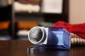 Modern fabric shaver and knitted clothes on wooden table indoors, closeup. Space for text Royalty Free Stock Photo