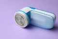 Modern fabric shaver for lint removing on purple background Royalty Free Stock Photo