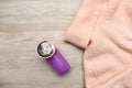 Modern fabric shaver for lint removing and sweater on wooden table, flat lay Royalty Free Stock Photo