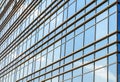Modern facade of glass and steel with open window reflecting sky Royalty Free Stock Photo