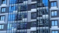 Modern facade of a new residential complex, blue glass facade glazing. Residential apartments or architecture of an