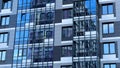 Modern facade of a new residential complex, blue glass facade glazing. Residential apartments or architecture of an