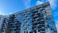 Modern facade of a new residential complex, blue glass facade glazing. Residential apartments or architecture of an