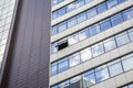 Modern facade of office building with glass and steel. One open window. Reflection sky and clouds. Exterior of futuristic business Royalty Free Stock Photo