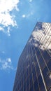 Modern facades with blue sky and white clouds on background