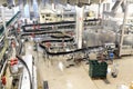 Modern factory in the food industry - beer brewery - conveyor belt with beer bottles and machines for production
