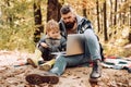 Modern family. Forest school and ecology education. Man bearded father and son with laptop in forest. Ecology upbringing