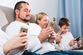 Modern family with smartphones at home Royalty Free Stock Photo