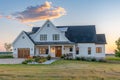 Modern farmhouse with gabled roof constructed by board and batten. Generative AI. Royalty Free Stock Photo