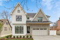 A modern farmhouse home with a white and brick exterior.