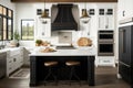 modern farmhouse kitchen with white cabinets, black island, and range hood Royalty Free Stock Photo