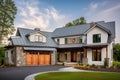 modern farmhouse with metal roof, wooden siding and stone accents