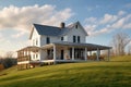 modern farmhouse, with wrap-around porch and swing, overlooking peaceful country landscape Royalty Free Stock Photo