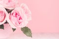 Modern fashion home interior in elegant style and pink color - rich lush roses in basket on white wood board, copy space, closeup.