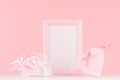 Modern fashion Valentine days background - trendy pink heart with ribbon, present and blank frame for text on white wood board. Royalty Free Stock Photo