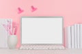 Modern fashion workplace - silver laptop with blank screen, white stationery, stickers magnet on soft pink background. Royalty Free Stock Photo