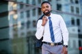 Modern fashionable african american business man portrait in urban city, walking to work in financial district Royalty Free Stock Photo