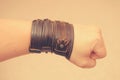 Modern fashionable leather and metal bracelets on the wrist.