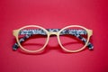 Modern fashionable spectacles on red background. Royalty Free Stock Photo