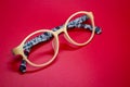 Modern fashionable spectacles on red background. Royalty Free Stock Photo