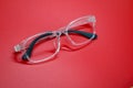 Modern fashionable spectacles on red background. Royalty Free Stock Photo