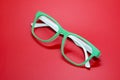 Modern fashionable spectacles on red background. Royalty Free Stock Photo