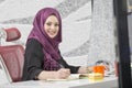 Modern female Arabian office worker in office