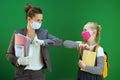 Modern female teacher and pupil greeted with elbow bump