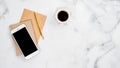 Modern feminine workplace with cup of coffee on white marble desk table. Flat lay, top view