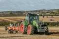 Modern fendt tractor pulling a plough