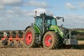 Modern fendt tractor pulling a plough