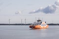 Modern ferry sailing with the wind turbines background