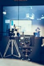 Modern film camera on a tripod in a broadcasting studio, spotlights and other equipment Royalty Free Stock Photo