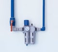 A modern filter with a water gauge for cleaning from debris and heavy metals, located on the wall, a water pipe water purification