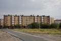 Modern five-storeyed house with flats. It was colored in red, orange and white colors